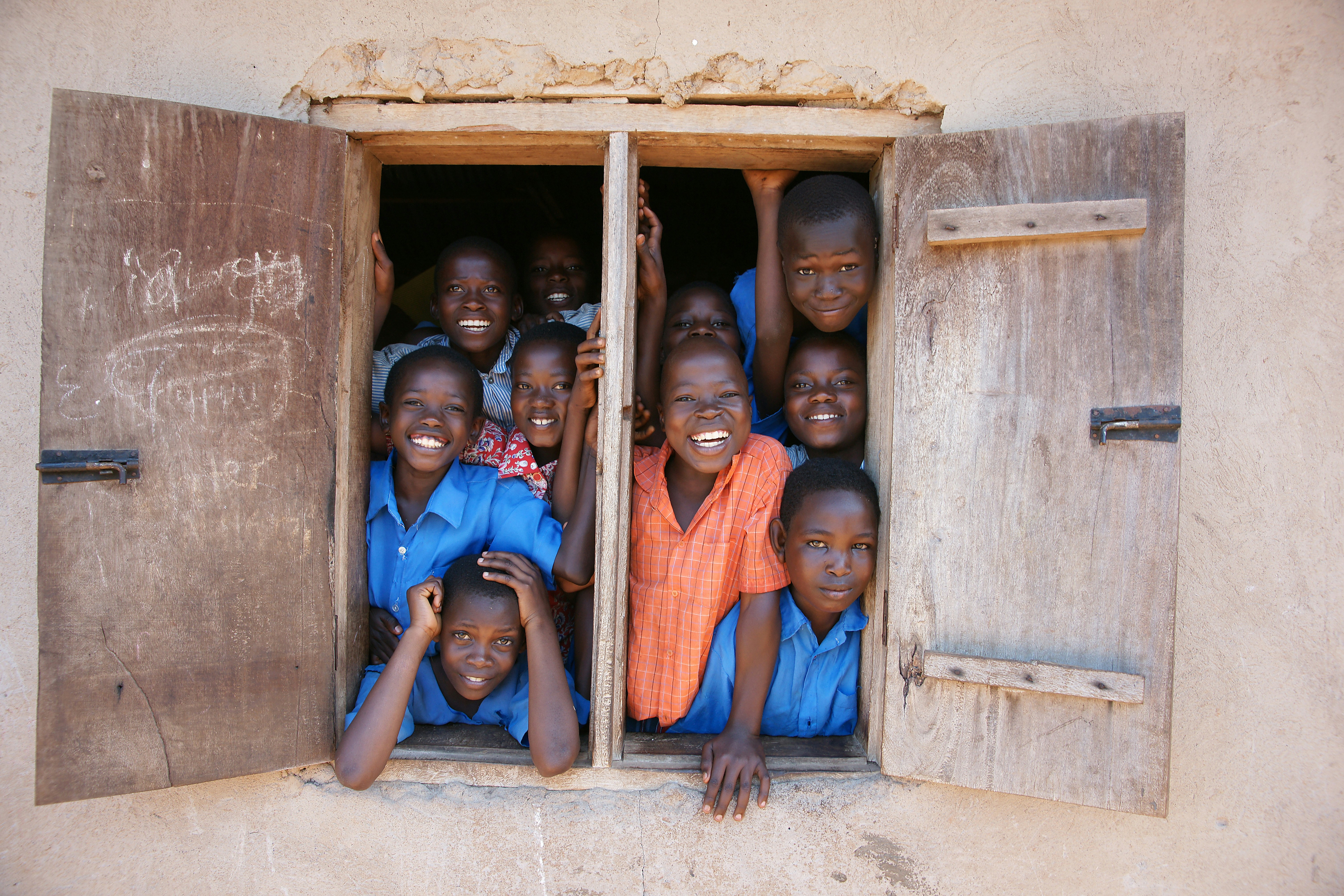 Youth looking out from a community center window