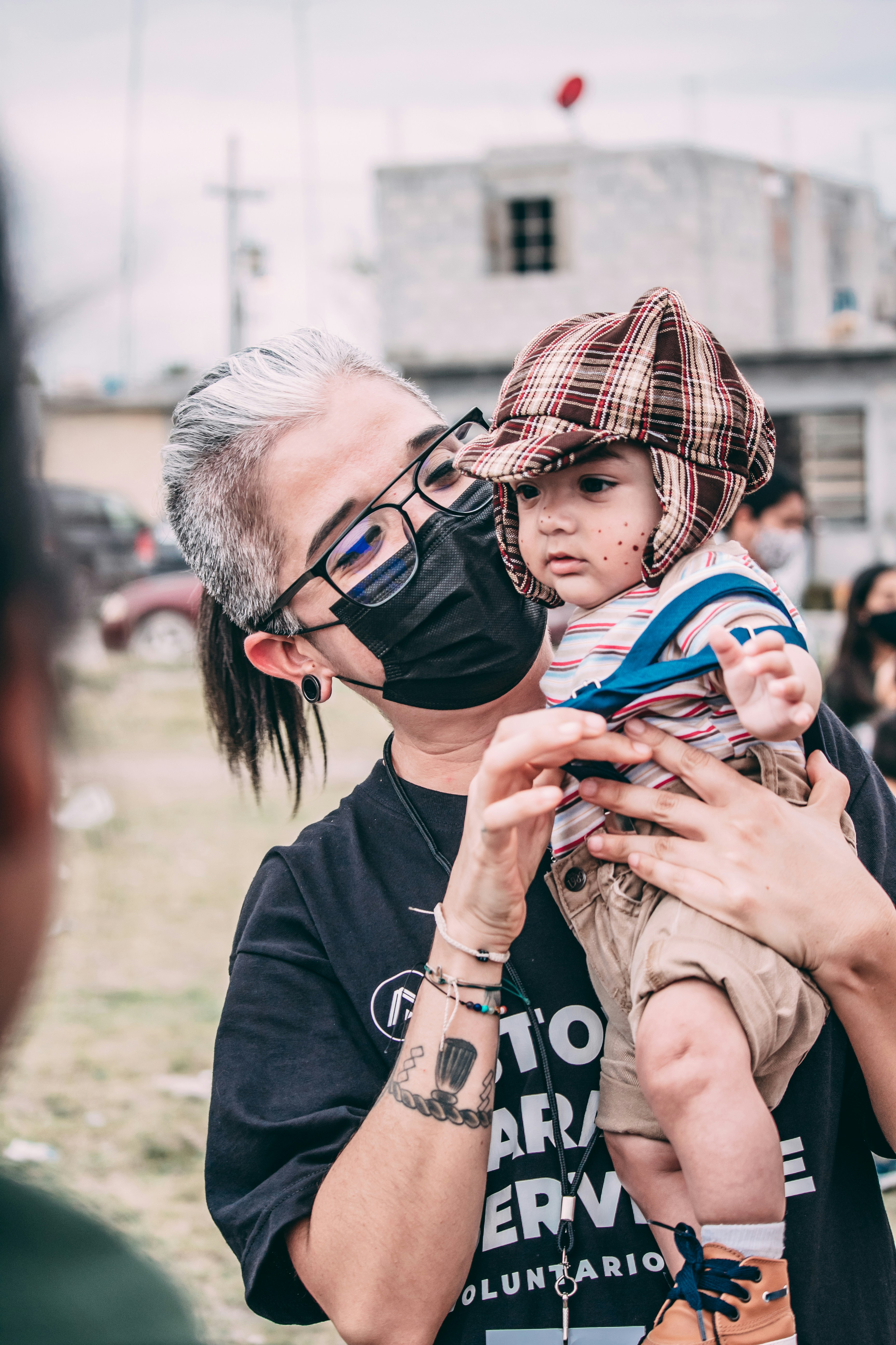 Volunteer supporting a child at a community event